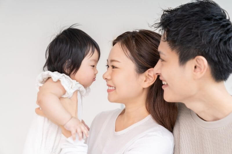portrait of asian parent and daughter , family of three