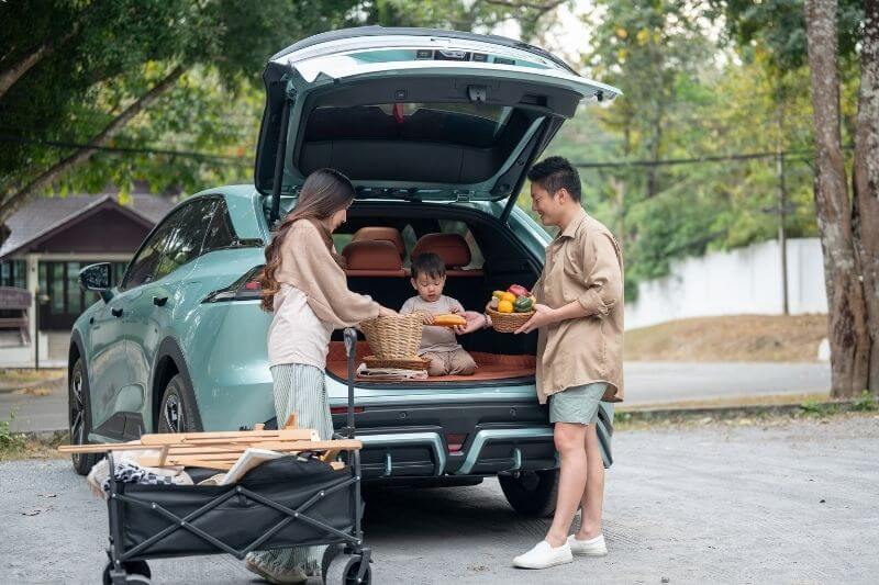 road trip with family parents packing the car for journey with young child