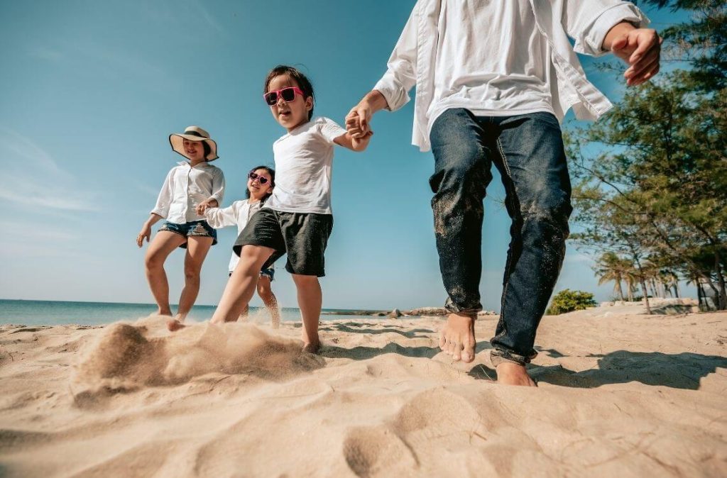 Asian family vacation at the beach with family relationships.Happy family travel on beach in holiday,Summer and vacations concept.