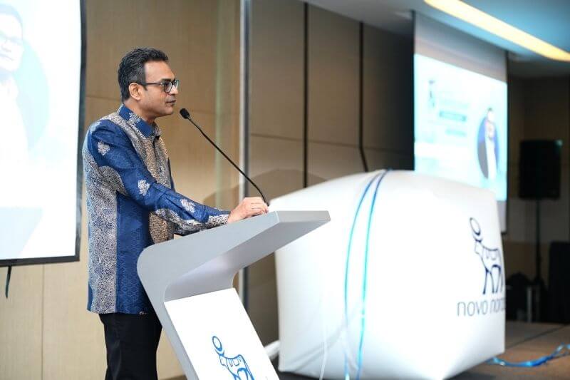 man giving speech on podium with mic