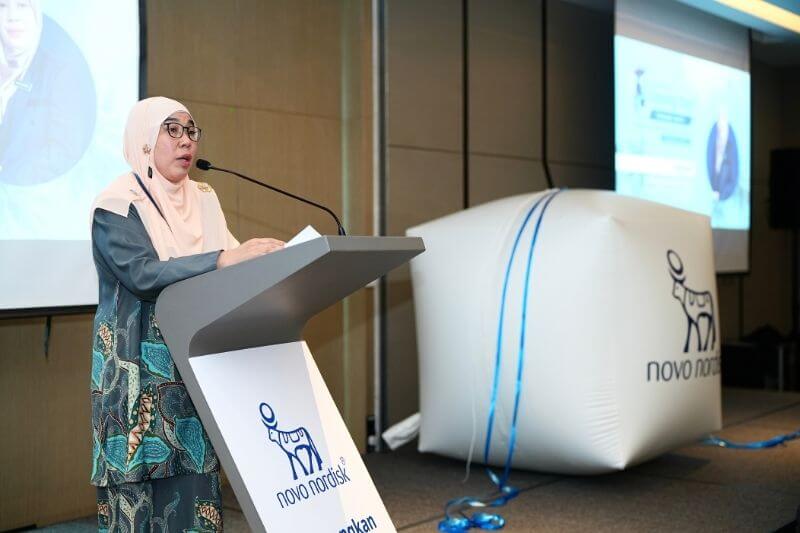 woman giving speech on podium for product launch