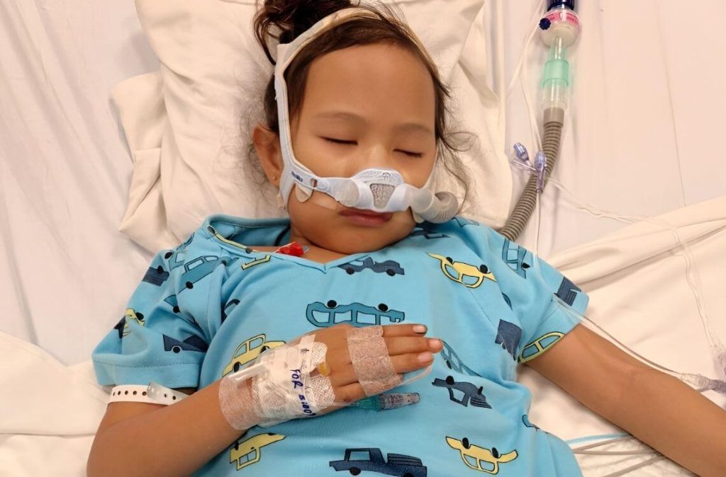 girl requiring breathing assistance in hospital