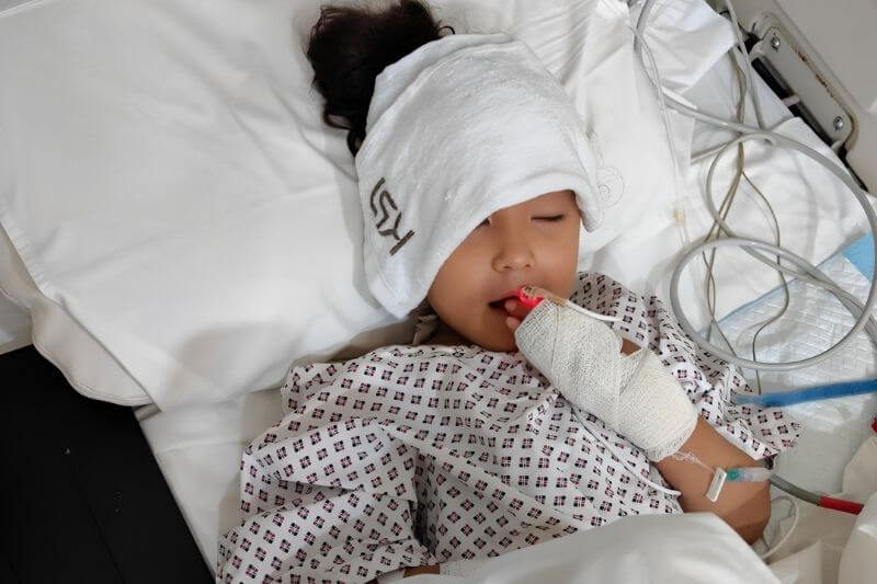 girl requiring breathing assistance in hospital