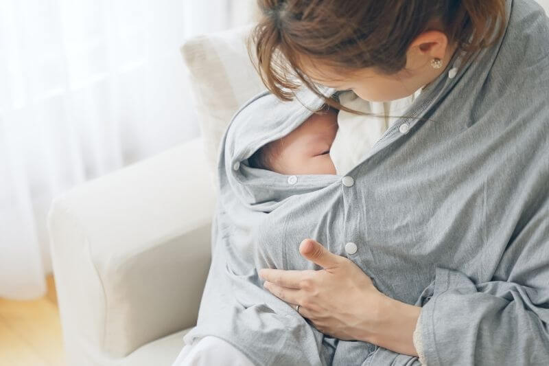 mum feeding child breastfeeding with feeding cover