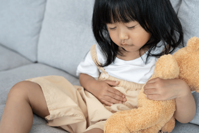young girl toddler having tummy ache