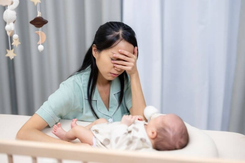 Woman suffer from exhaustion while taking care of the newborn baby