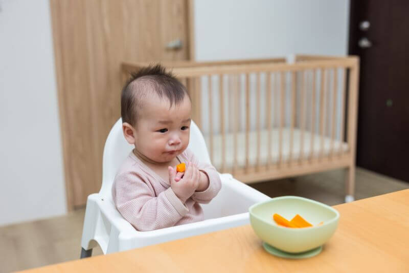 baby starting solid in high chair