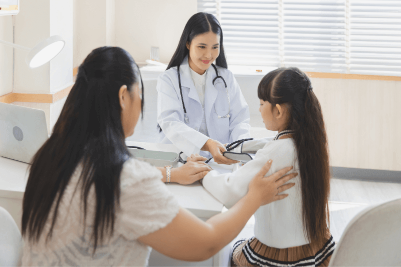 Doctor explaining healthcare to Malaysian family