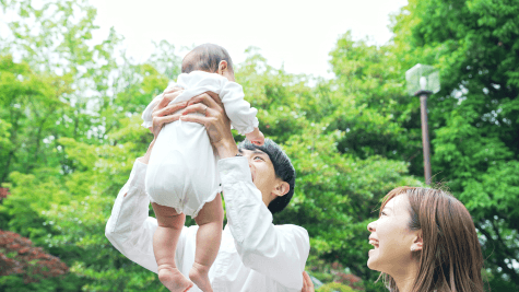 Parent taking baby outdoors in warm weather