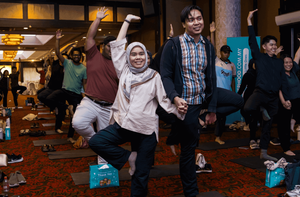 Couple in tree pose yoga at Malaysia Tourism Family Active and Wellness Expo 2026