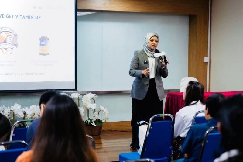 female professional talking on podium parenting talk forum session