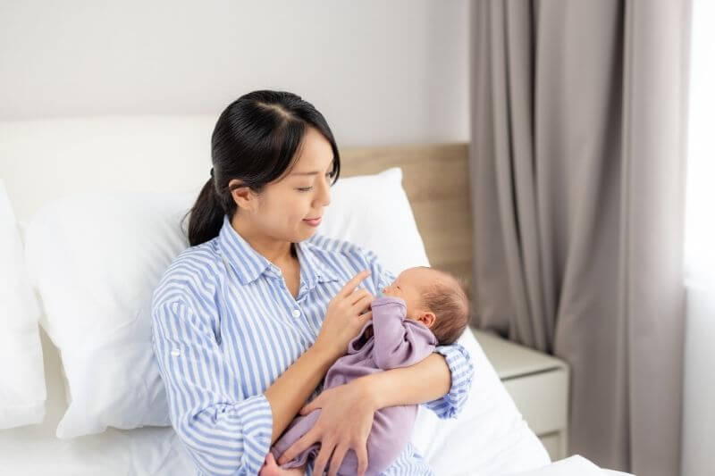 Asian mom hold with her son at home