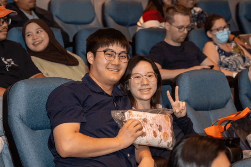 A couple attends the Motherhood.com.my Parentcraft Workshop and holds a goodie bag.
