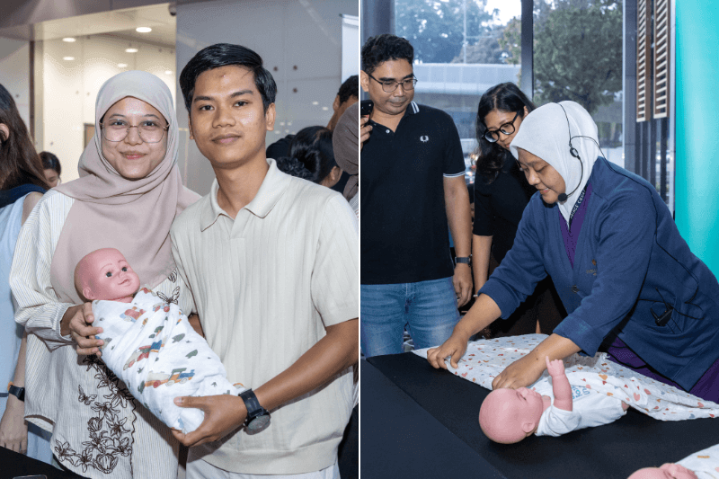 Parents-to-be practise newborn care with a doll during the Parentcraft Workshop.