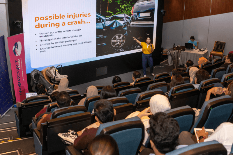 A speaker discusses car safety with attendees during the Parentcraft Workshop.