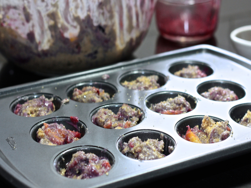 Blueberry muffin mix in a muffin pan