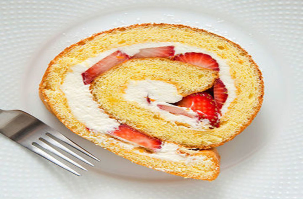 A slice of rolled strawberry roulade